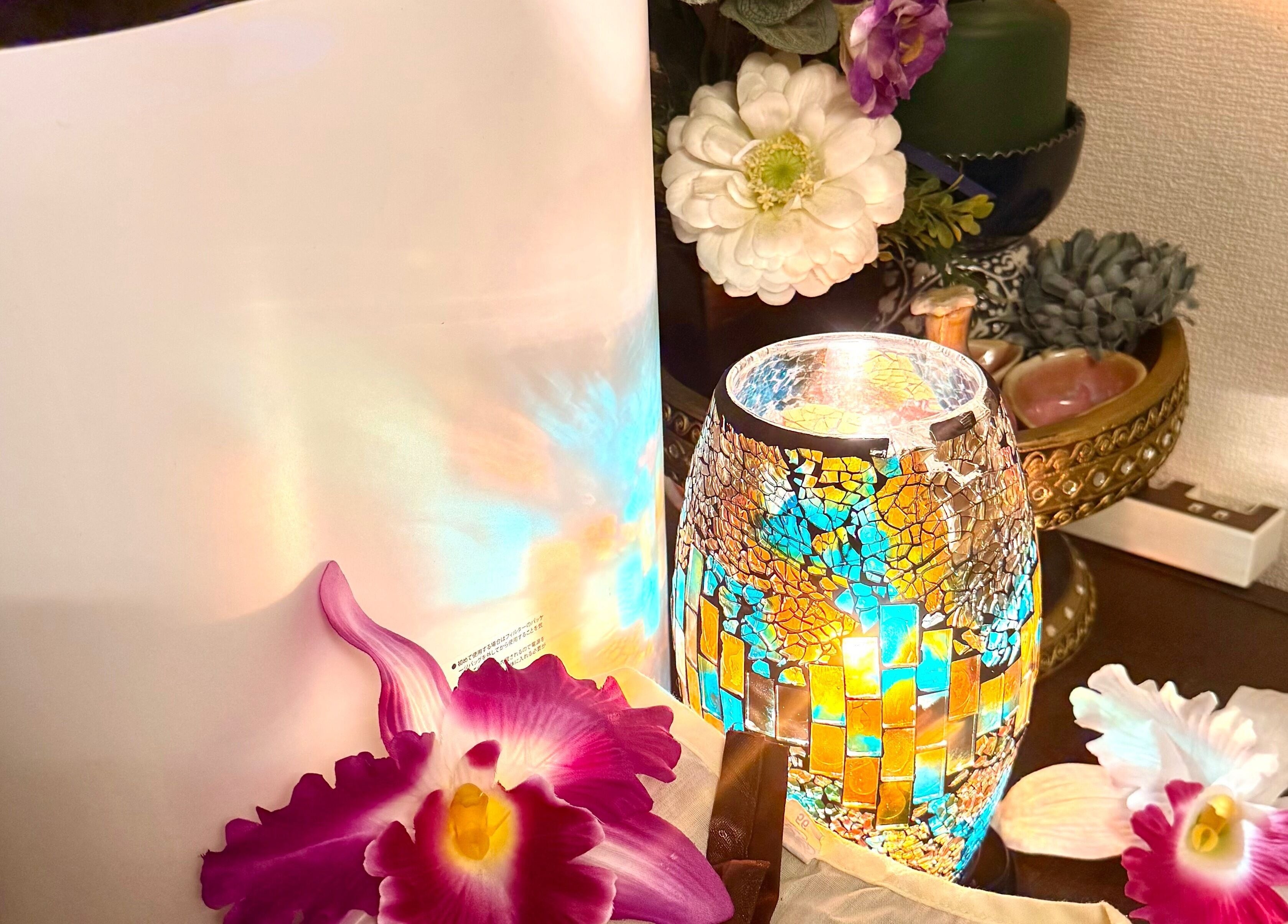 Mosaic lamp and orchids at Jasmine Thaispa in Shinjuku City, Tokyo, JP create a serene wellness ambiance.