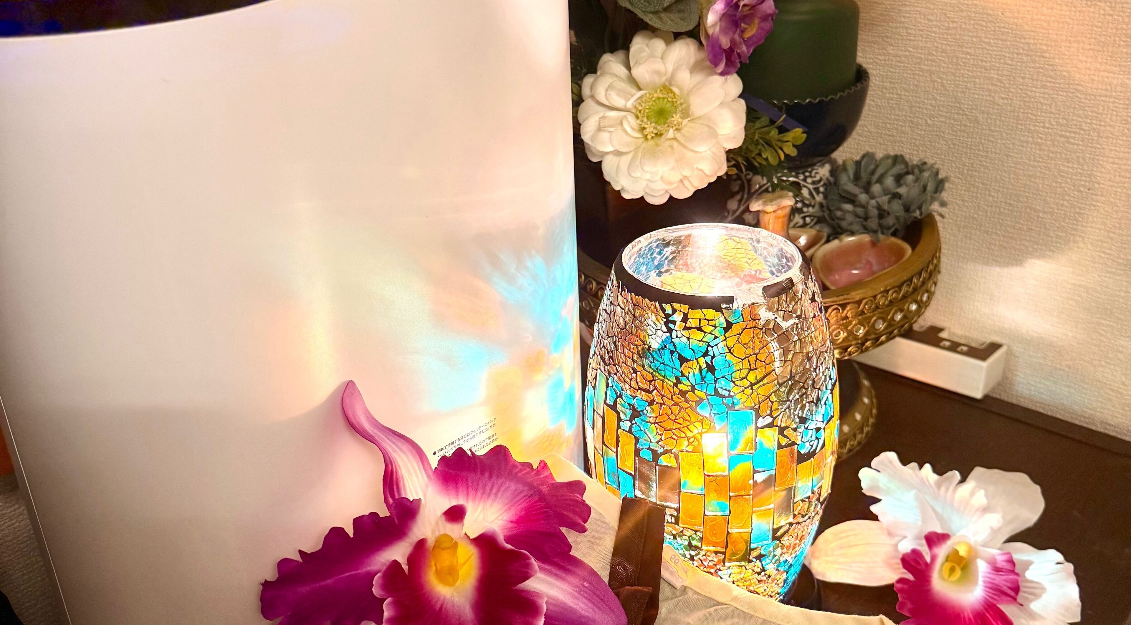 Mosaic lamp and orchids at Jasmine Thaispa in Shinjuku City, Tokyo, JP create a serene wellness ambiance.