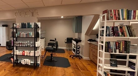 Interior of Freya Beauty Salon in Derry, New Hampshire, US featuring hair products and seating.