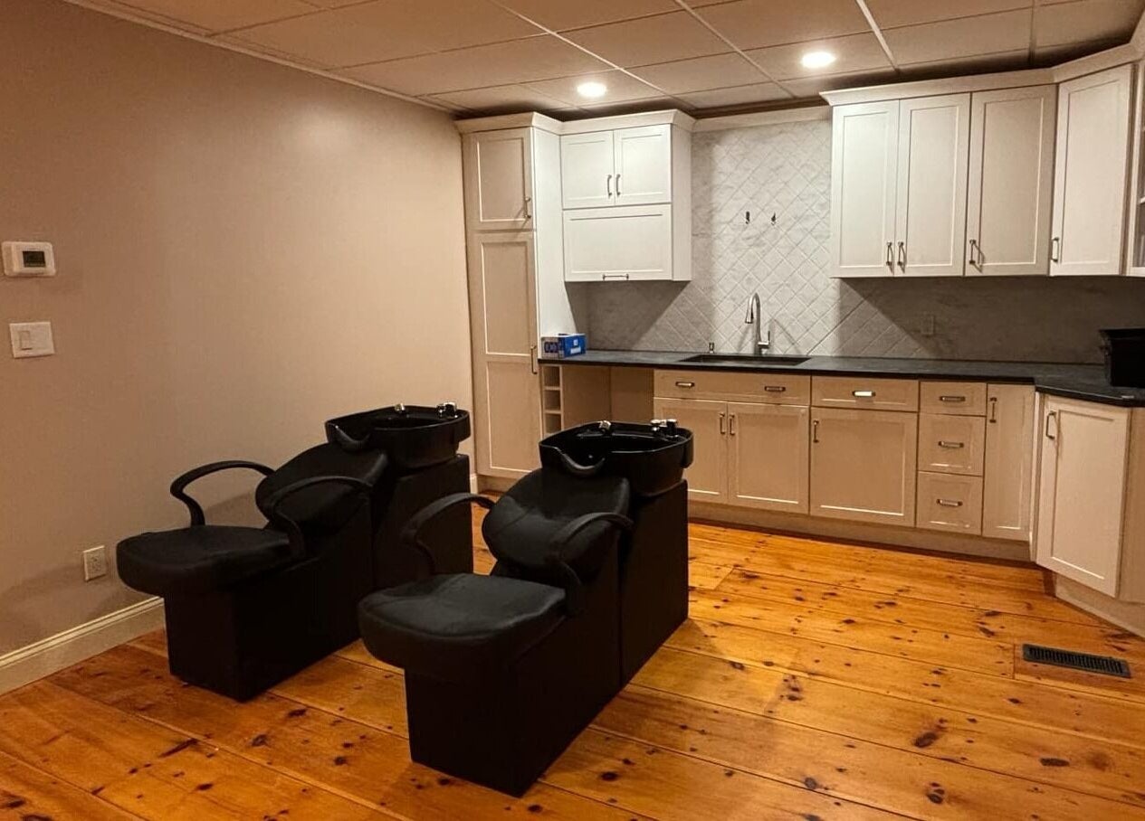 Freya Beauty Salon in Derry, New Hampshire, US, featuring stylish washing stations and modern cabinetry.