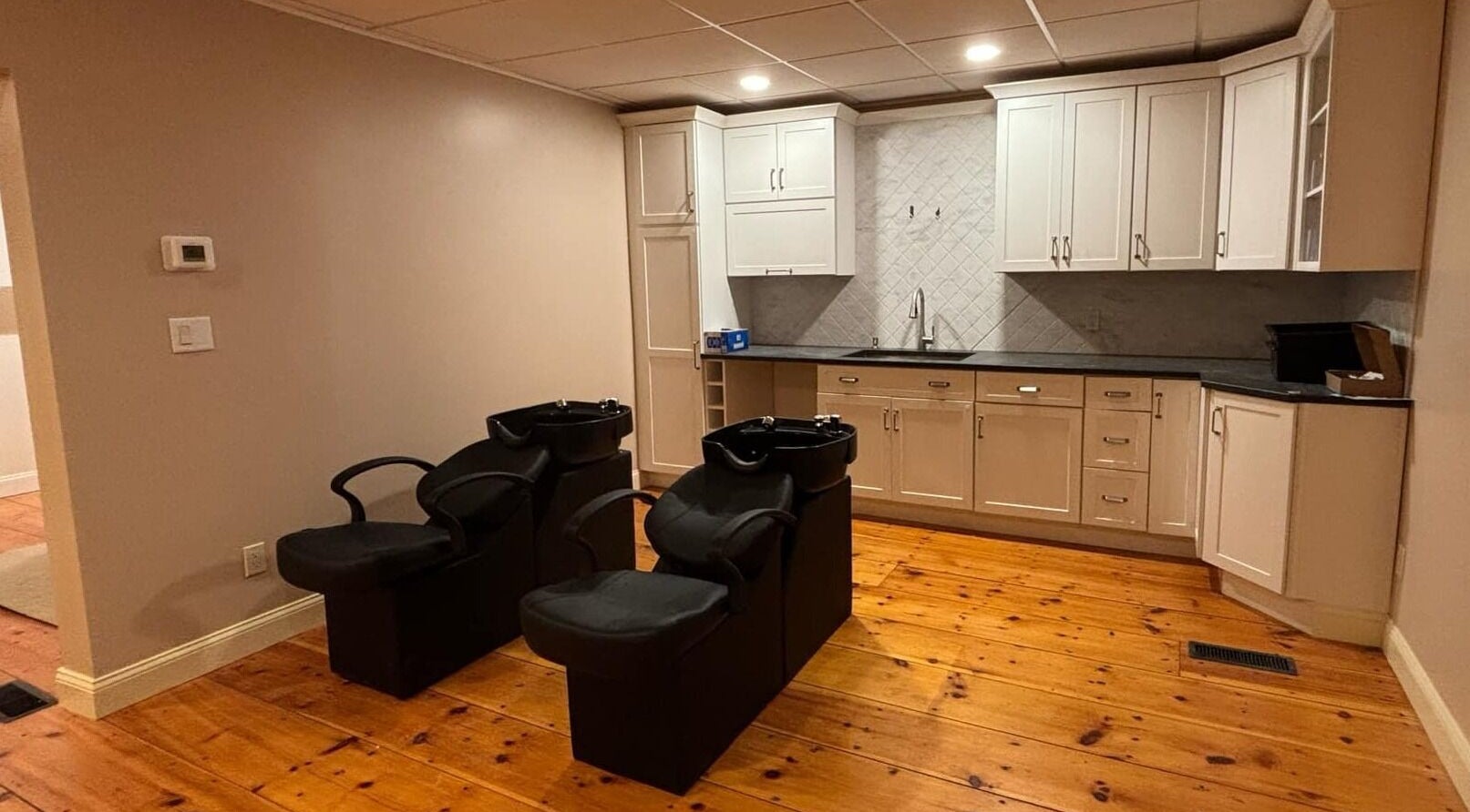 Freya Beauty Salon in Derry, New Hampshire, US, featuring stylish washing stations and modern cabinetry.