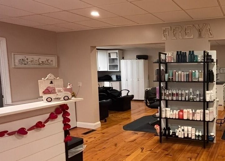 Interior of Freya Beauty Salon in Derry, New Hampshire, US, featuring cozy decor and product displays.