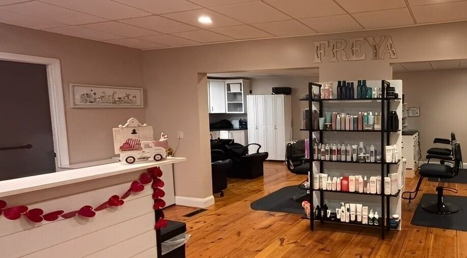 Interior of Freya Beauty Salon in Derry, New Hampshire, US, featuring cozy decor and product displays.