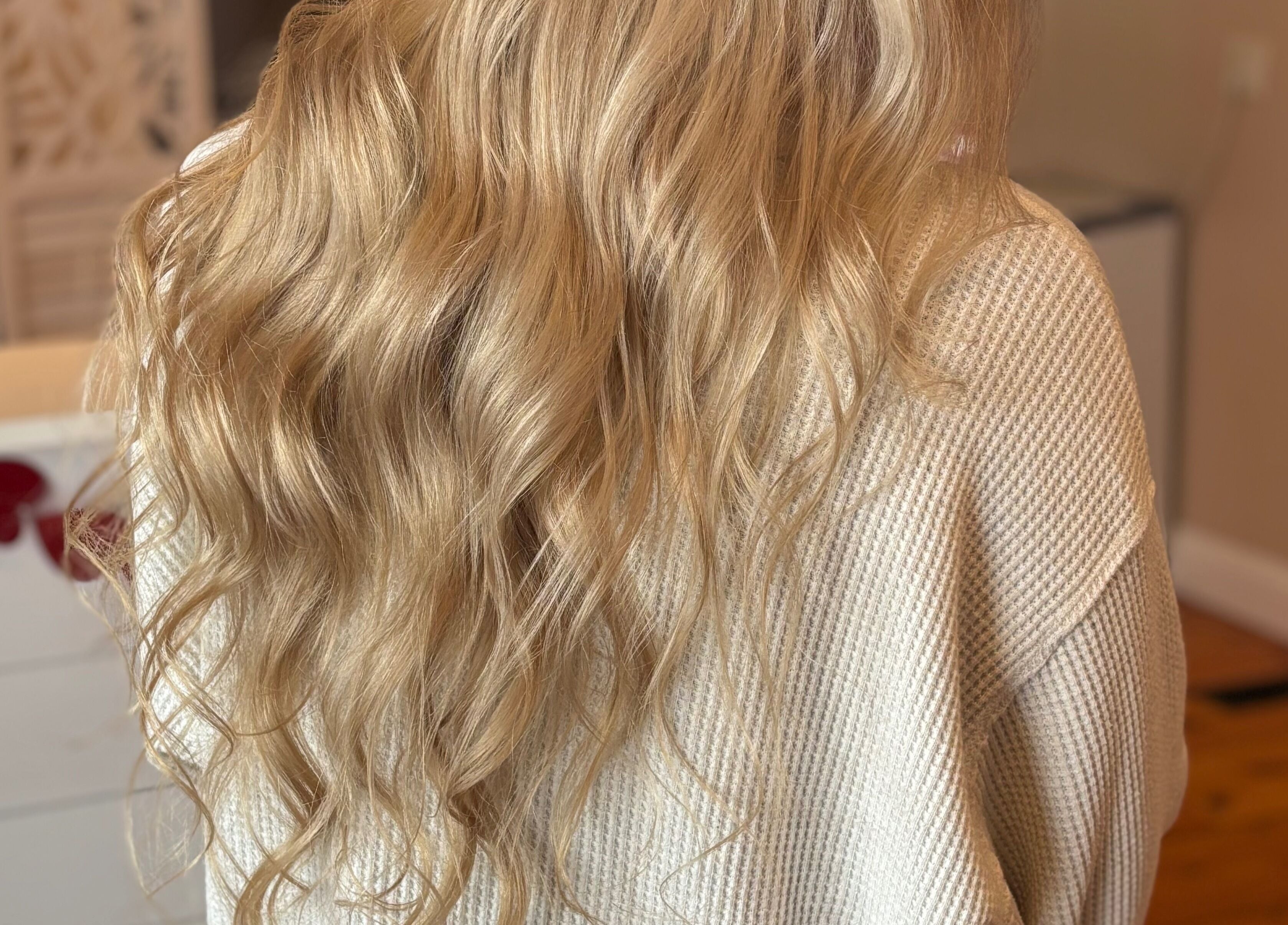 Long, blonde, wavy hair styled beautifully at Freya Beauty Salon, Derry, New Hampshire, US.