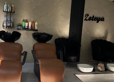 Luxurious wash area at Zoteya Beauty Salon, Sandton, Gauteng, ZA. Cozy chairs and premium hair products displayed.