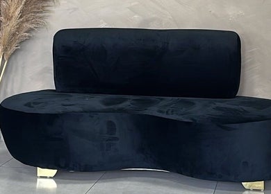 Luxurious black velvet sofa at Zoteya Beauty Salon in Sandton, Gauteng, ZA, adds modern elegance to the space.