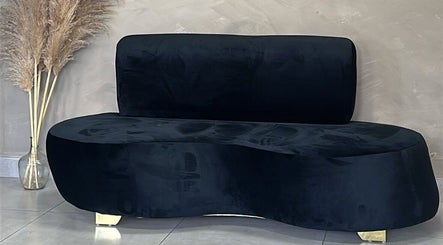 Luxurious black velvet sofa at Zoteya Beauty Salon in Sandton, Gauteng, ZA, adds modern elegance to the space.