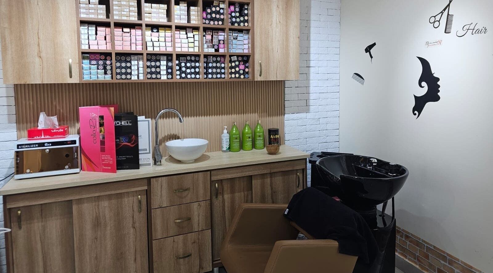 Hair station at Bloomself Beauty Ladies Saloon, Abu Dhabi, AE with modern sink and product shelves for treatments.