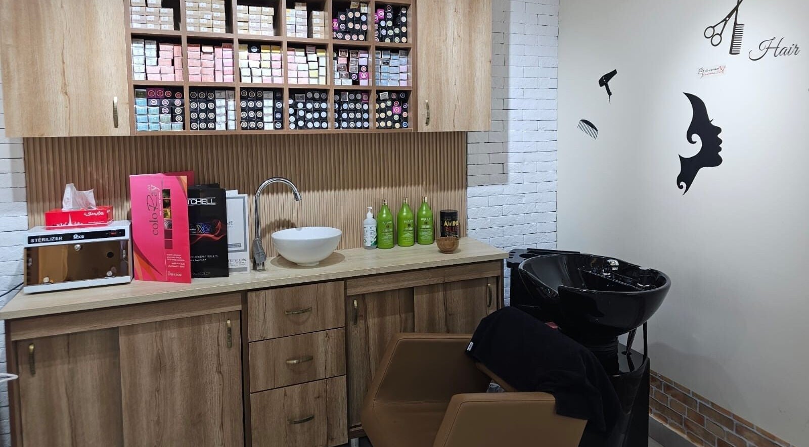 Hair station at Bloomself Beauty Ladies Saloon, Abu Dhabi, AE with modern sink and product shelves for treatments.