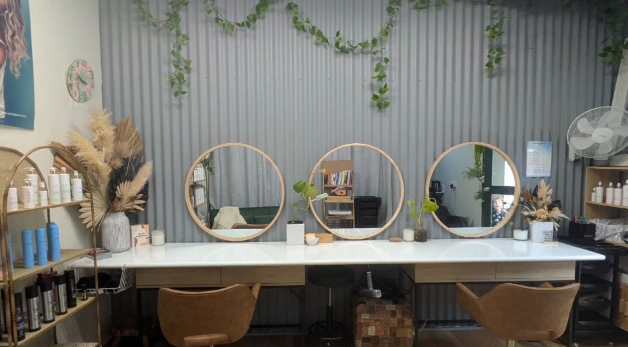 Modern salon interior at Sarah Jane Hair Craft, Melbourne, Victoria, AU, featuring round mirrors and stylish decor.