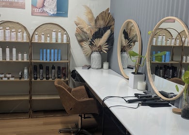 Stylish hair station at Sarah Jane Hair Craft, Melbourne, Victoria, AU, with mirrors and products.