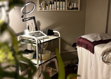 Cozy treatment room at Image Beauty Clinic, County Tipperary, IE, featuring a massage bed and skincare equipment.