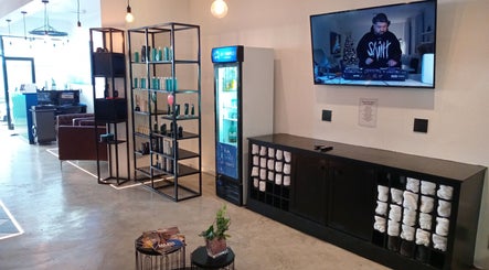 Interior view of St Tropez Homme Barbershop in Cape Town, Western Cape, ZA with modern decor and comfortable seating.