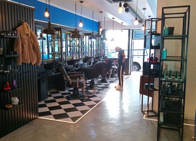 Interior of St Tropez Homme Barbershop in Cape Town, Western Cape, ZA, featuring vintage barber chairs and modern decor.