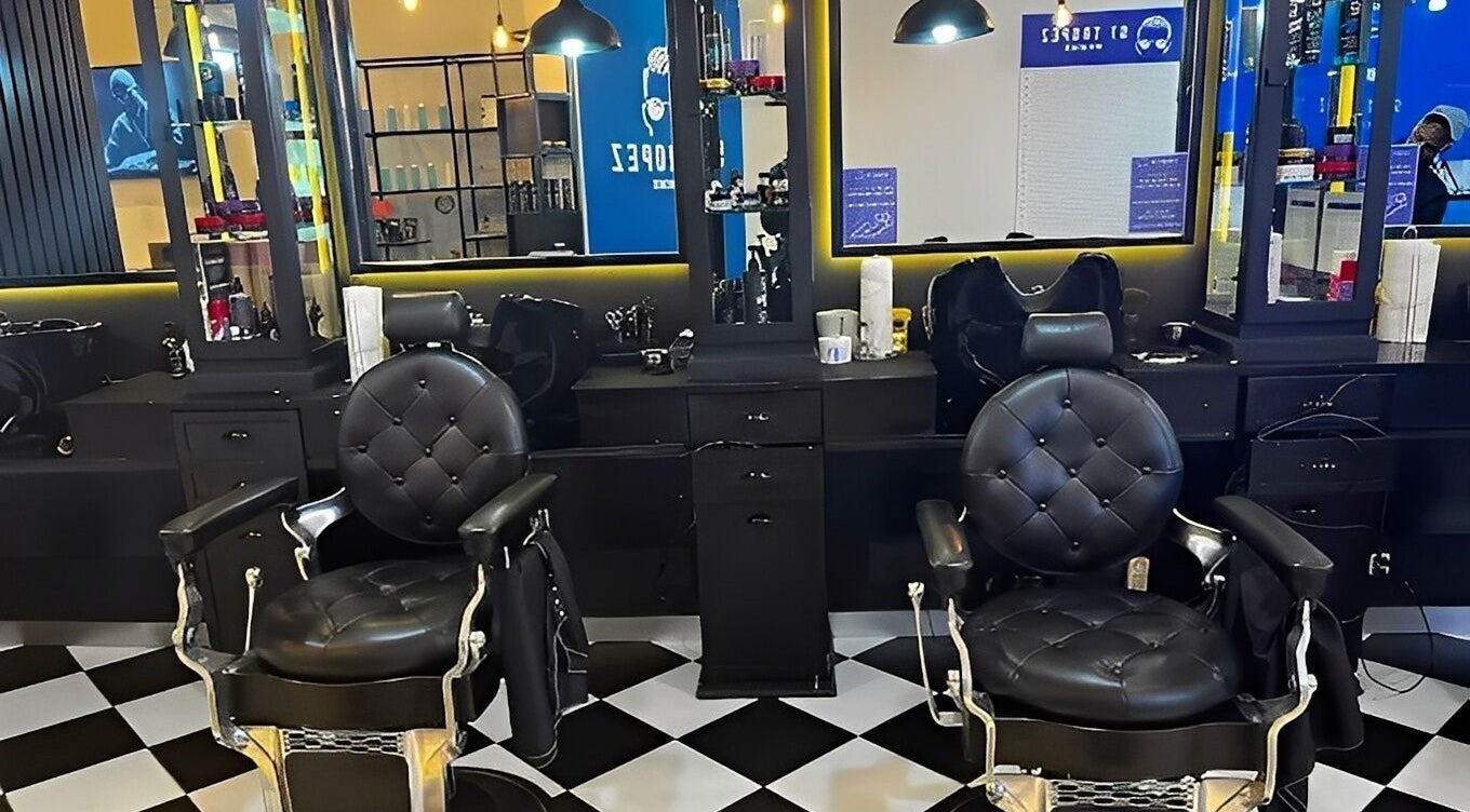 Chic barber chairs at St Tropez Homme Barbershop, Cape Town, Western Cape, ZA, offering premium grooming services.