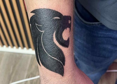 Lion tattoo inked on forearm at Indecisive Create, Auckland, Auckland, NZ. Bold, black design on skin.