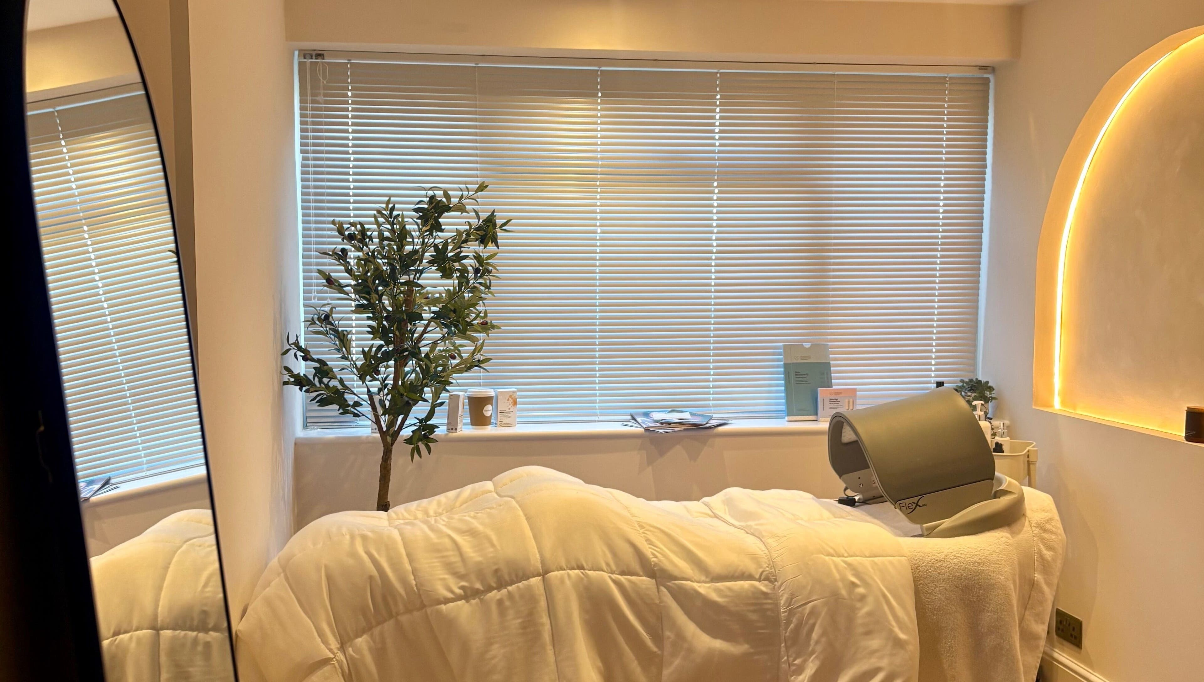Serene treatment room at BareFacial, Thatcham, England, GB, featuring a treatment bed and soft lighting.