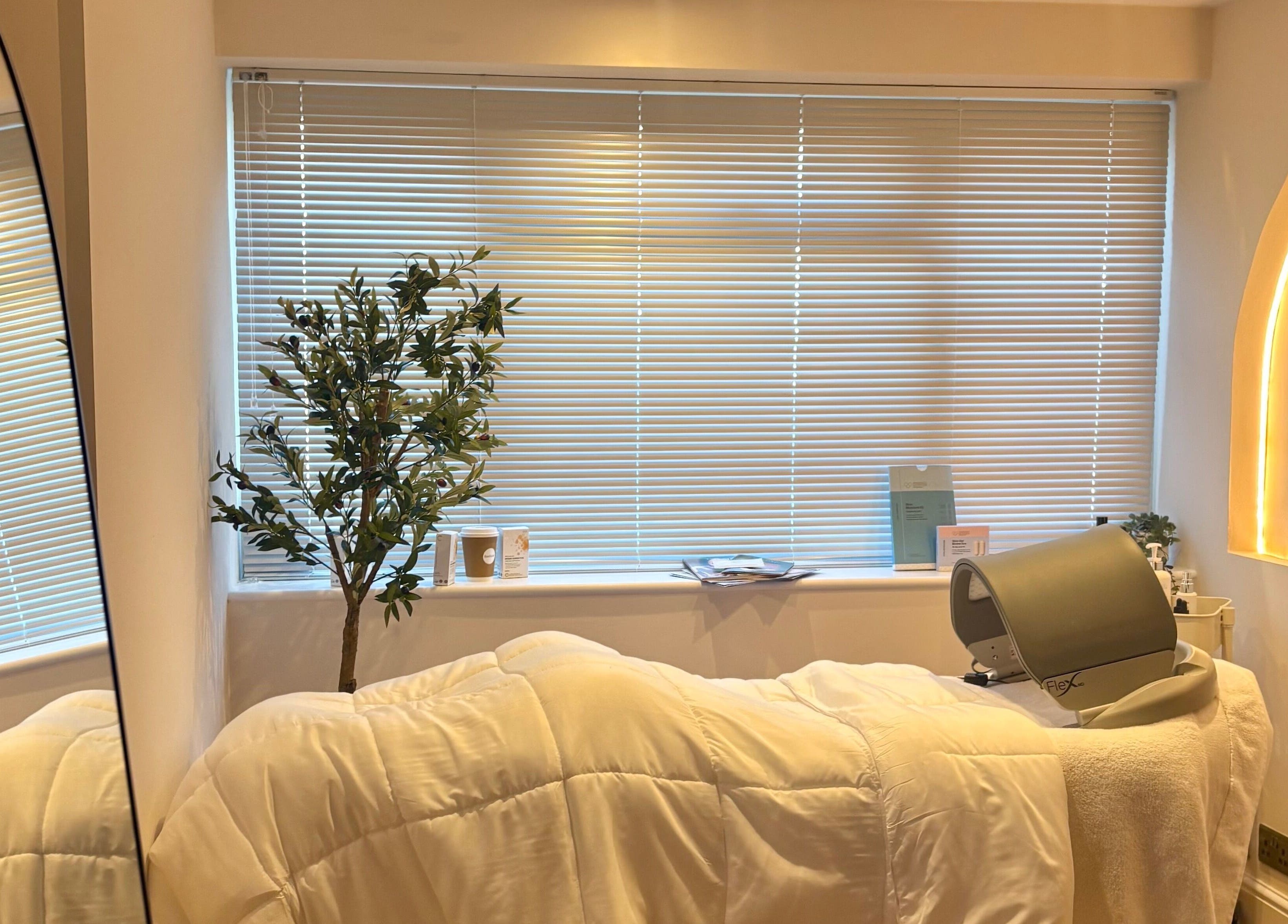 Serene treatment room at BareFacial, Thatcham, England, GB, featuring a treatment bed and soft lighting.