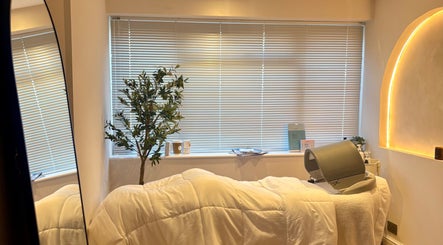 Serene treatment room at BareFacial, Thatcham, England, GB, featuring a treatment bed and soft lighting.