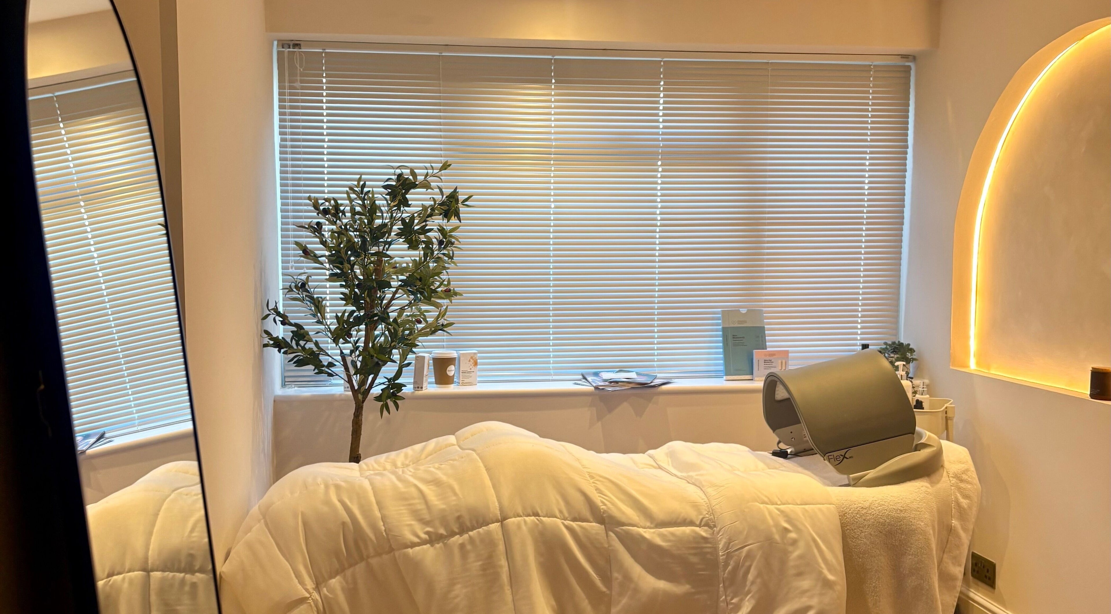 Serene treatment room at BareFacial, Thatcham, England, GB, featuring a treatment bed and soft lighting.