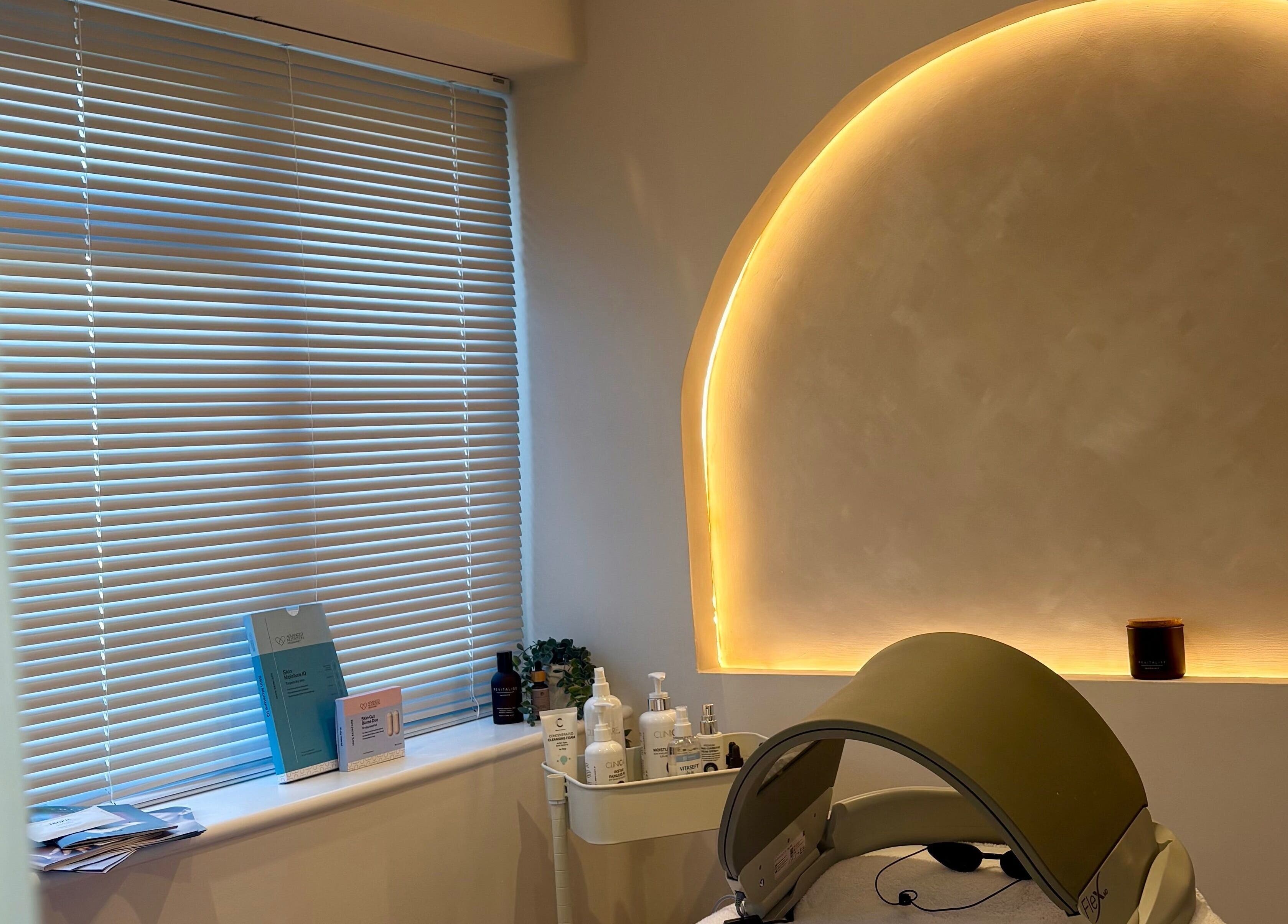 Calming treatment room at BareFacial in Thatcham, England, GB with ambient lighting and skincare products.