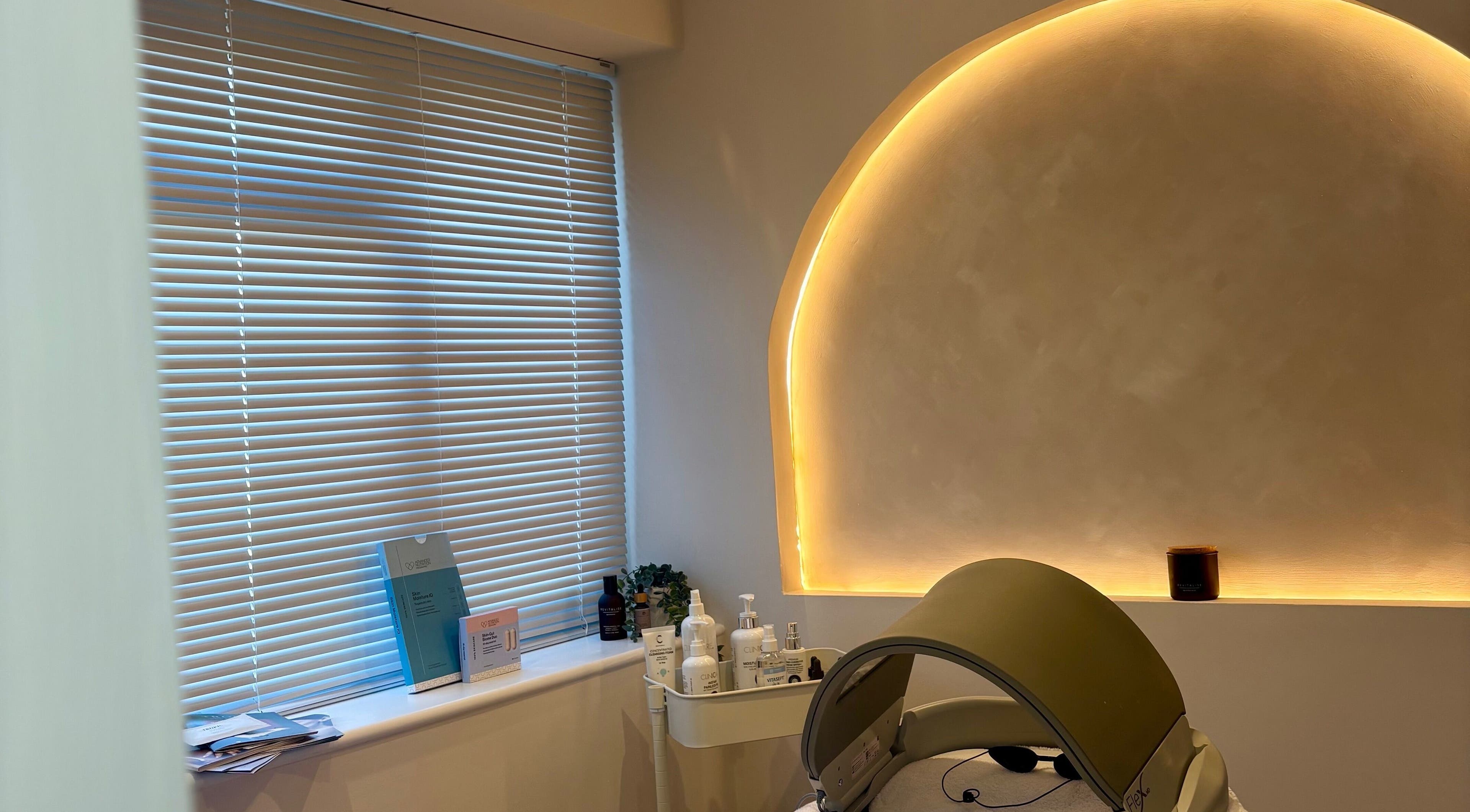 Calming treatment room at BareFacial in Thatcham, England, GB with ambient lighting and skincare products.