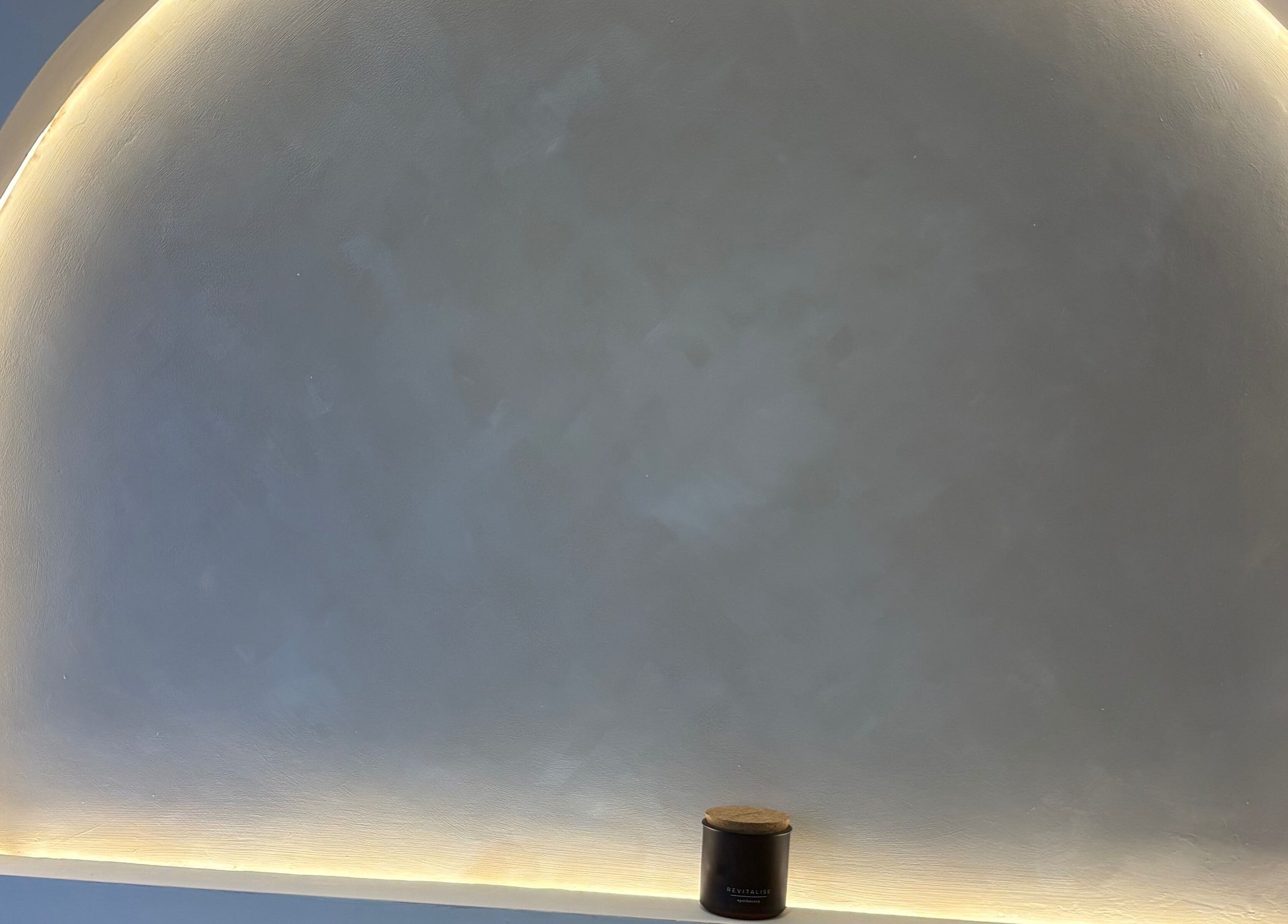 Softly lit archway with a candle at BareFacial, Thatcham, England, GB. Perfect relaxation ambiance.