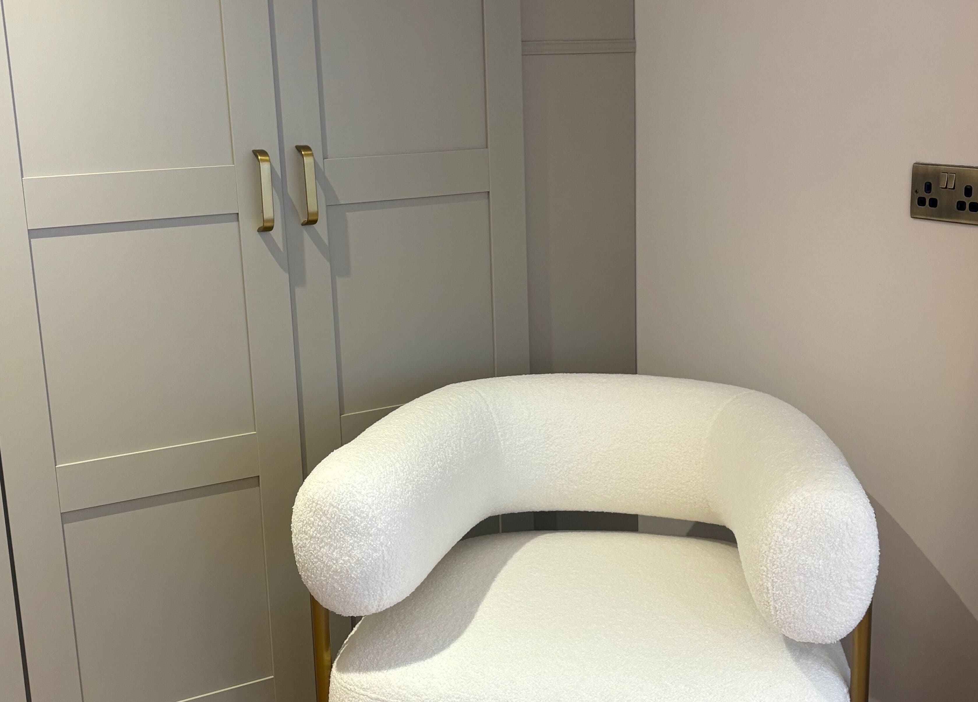Elegant white chair in BareFacial, Thatcham, England, GB highlights luxurious decor and comfort.