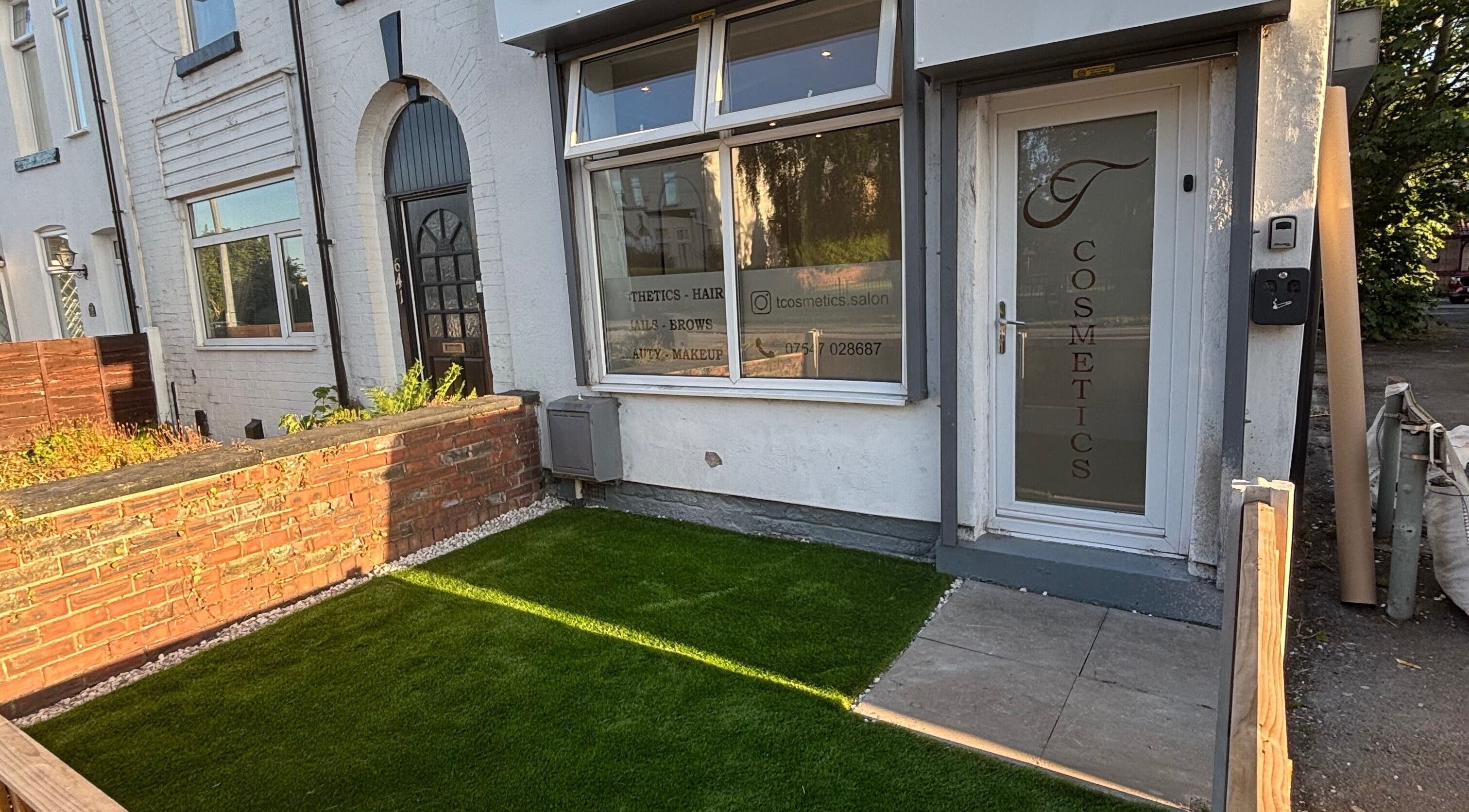 Front view of Tcosmetics in Swinton, England, GB showcasing stylish entrance and branded glass door.