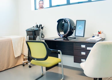 Interior of Micure Aesthetics Clinic in Gaborone City, BW, featuring a treatment table and advanced skincare equipment.