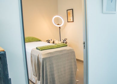 Treatment room at Micure Aesthetics Clinic, Gaborone City, BW. Cozy bed with a towel and a ring light.