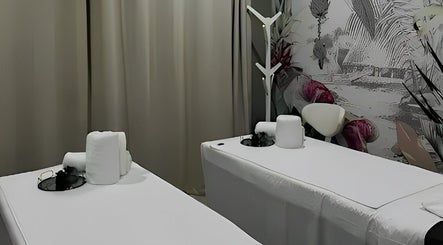Relaxing massage room at Apple Blossoms Beauty and Spa, Roodepoort, Gauteng, ZA with elegant decor and cozy beds.