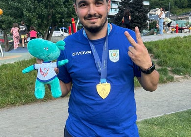 Man in park holding toy and medal near AC Physiotherapy, Lemesos, Lemesos, CY.