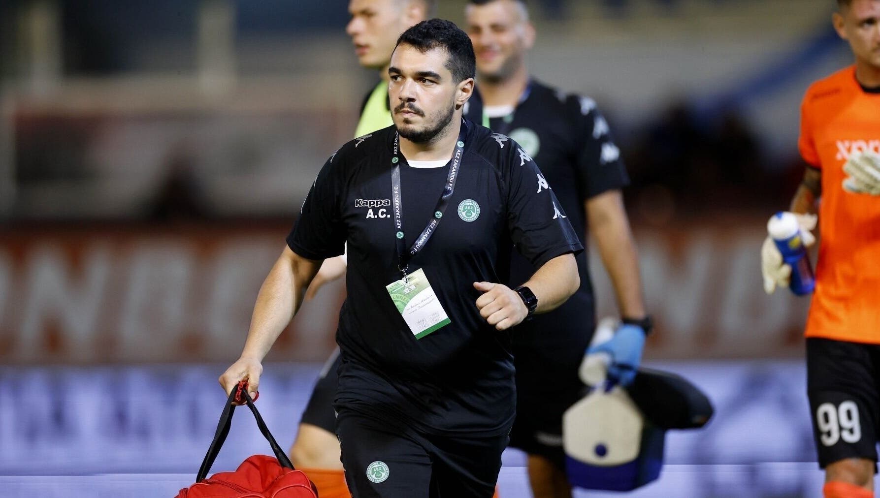 A professional holds a sports bag at AC Physiotherapy, Lemesos, Lemesos, CY, showcasing active wellness support.