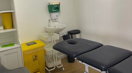 Treatment room at AF Sports Therapy in Birmingham, England featuring a therapy bed and clean facilities.