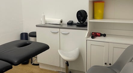 AF Sports Therapy treatment room in Birmingham, England, GB featuring massage table and therapy tools.