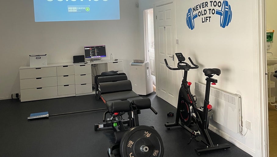 AF Sports Therapy fitness room in Birmingham, England with exercise bike and equipment.