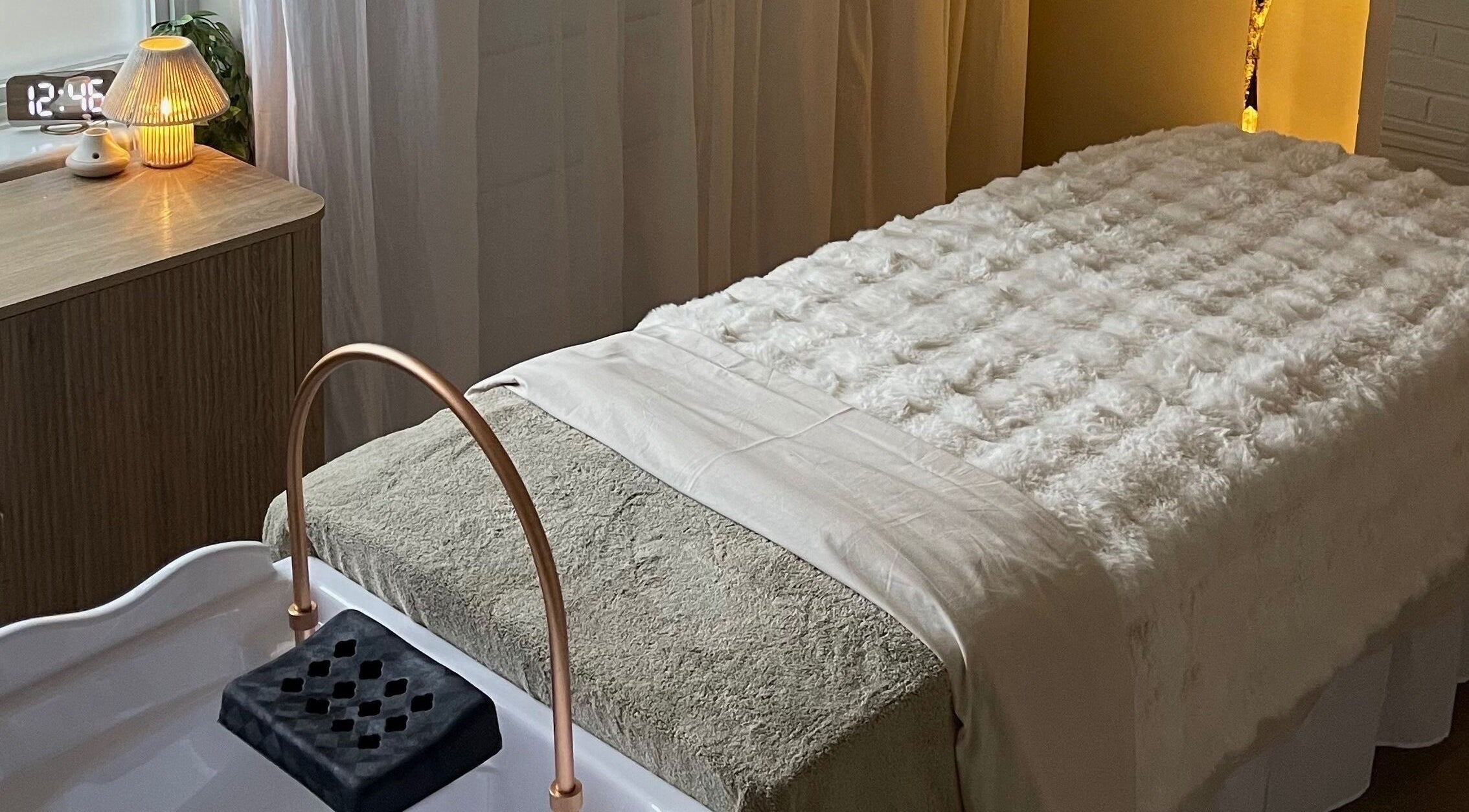 Relaxing treatment room at The HEAD SPAce Cambridgeshire, Huntingdon, England, GB with plush linens and ambient lighting.