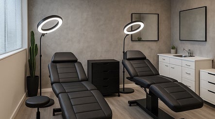 Sophisticated treatment room at Pink Cloud Studio, Dee Why, New South Wales, AU, features modern black chairs.