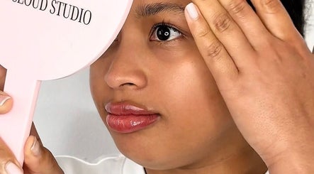 A client examines her skin in a Pink Cloud Studio mirror at Dee Why, New South Wales, AU.