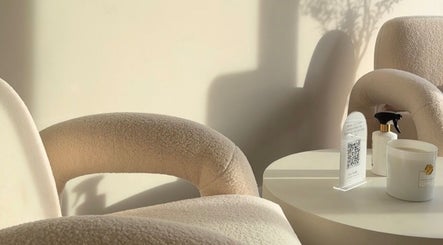 Bright, cozy seating area at BeautyByCoChlo | Chloe Turton, Normanton, England, GB, with cream chairs and table.