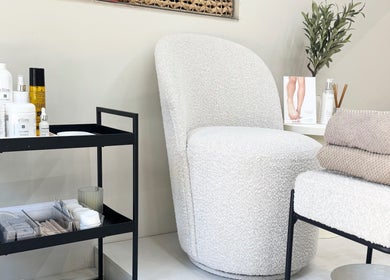 Elegant seating area at BeautyByCoChlo | Chloe Turton, Normanton, England, GB with spa products and towels.