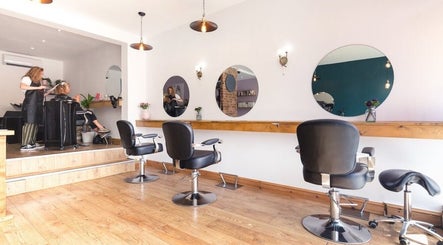 Interior of Kyleramsdenhair Co/Cobane in Stockport, England, showcasing modern salon chairs and mirrors.