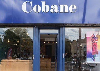 Kyleramsdenhair Co/Cobane storefront with blue signage in Stockport, England, GB, displaying a vibrant atmosphere.