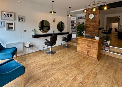 Modern salon interior at Kyleramsdenhair Co/Cobane, Stockport, England, GB featuring chic chairs and decor.