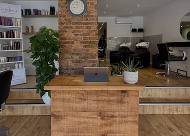 Kyleramsdenhair Co/Cobane's elegant salon in Stockport, England, GB showcases modern styling chairs and beauty product displays.