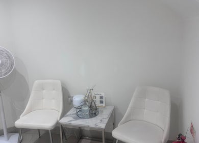 Elegant waiting area at Sculpt With Sherree, Luton, England, GB with white chairs and decor.