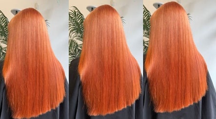 Vibrant red hair styled at Hair by Zara Hinde, Glasgow, Scotland, GB, showcasing sleek, shiny finish.