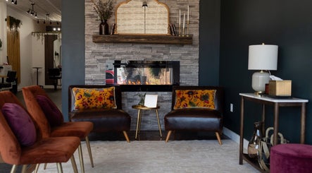 Inviting lounge at Samis Signature Styles in Marshfield, Wisconsin, US with elegant decor and warm fireplace.