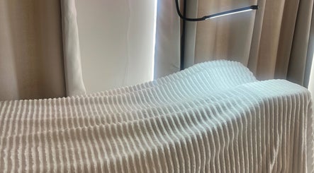 Comfortable treatment bed at Certified Beauty, Patchway, England, GB, featuring elegant lighting and cozy ambiance.
